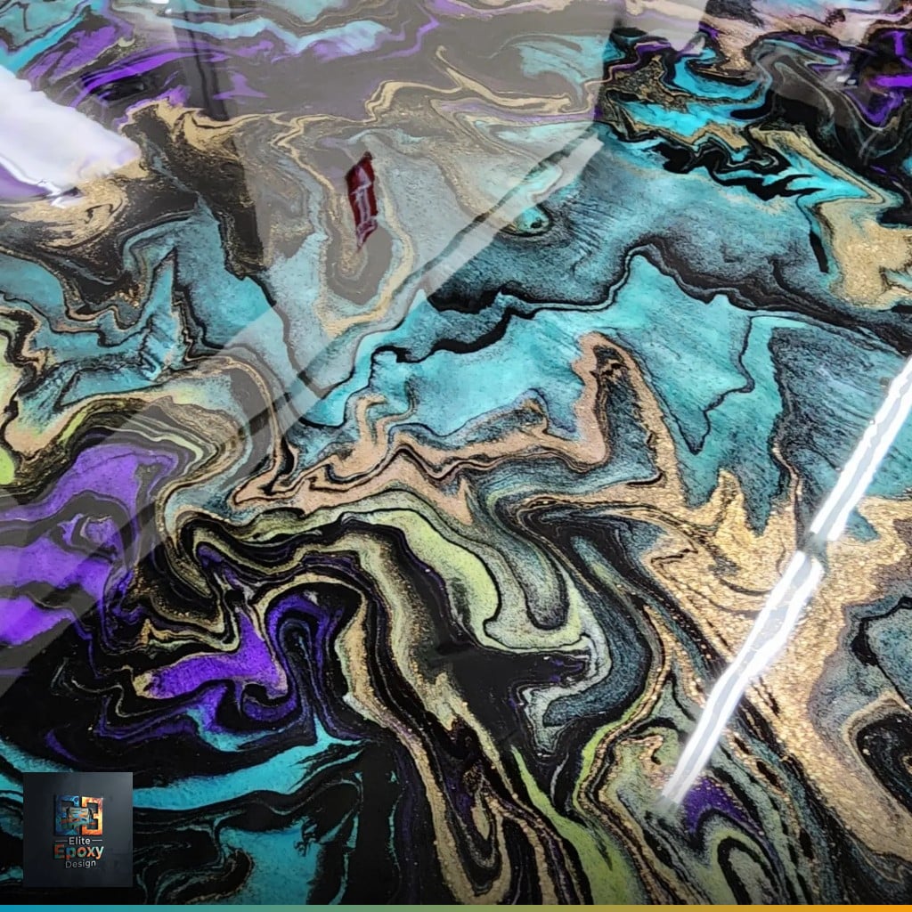 Teal, violet, gold and black metallic epoxy floor with an intricate marbled cell pattern