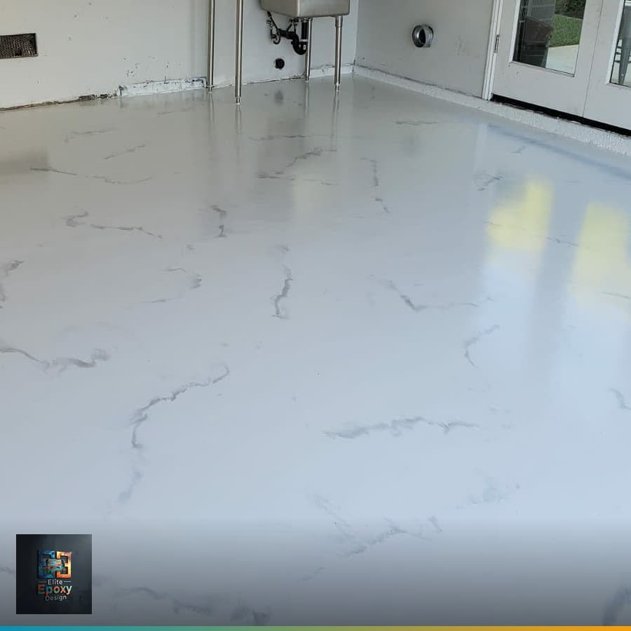 White Calacatta-style metallic epoxy floor with fine gray veining in a bright empty room